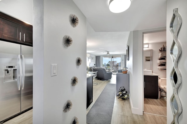 hallway with light hardwood / wood-style floors