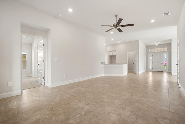 unfurnished living room featuring ceiling fan