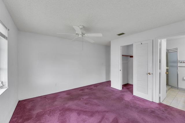 unfurnished bedroom with a textured ceiling, light carpet, ceiling fan, and a closet