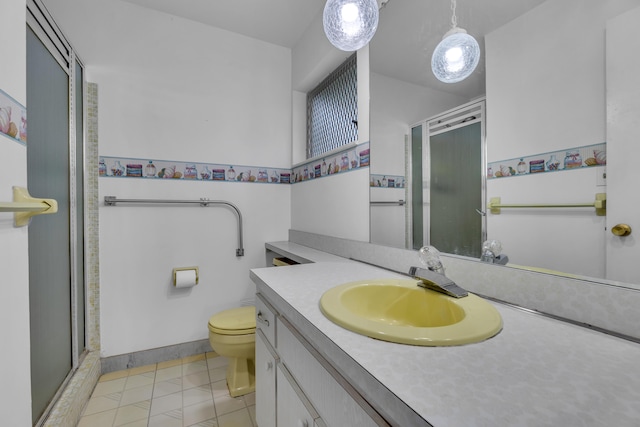 bathroom featuring vanity, toilet, an enclosed shower, and tile patterned floors