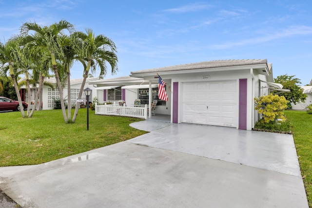 single story home featuring a front yard and a garage