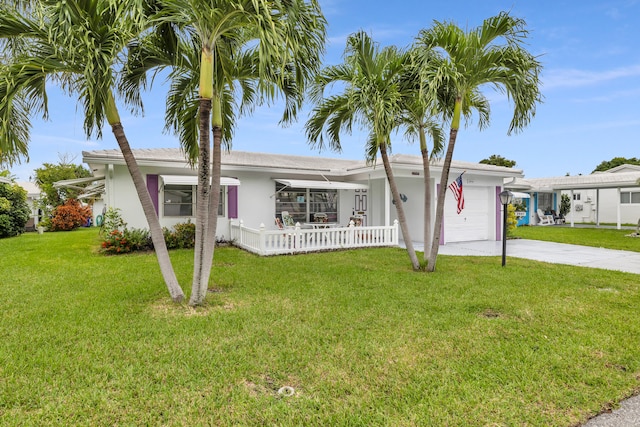 ranch-style home with a garage and a front lawn