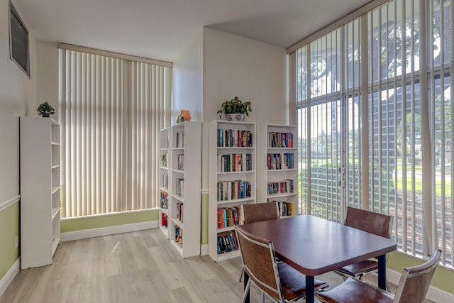 dining room featuring a healthy amount of sunlight and light hardwood / wood-style floors