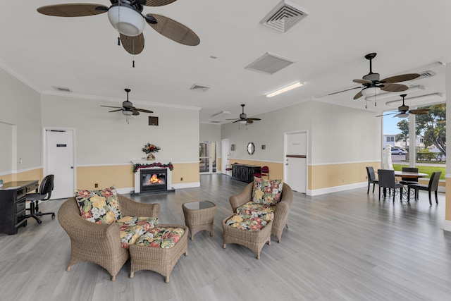 living room with light hardwood / wood-style flooring and ornamental molding