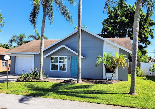 ranch-style house featuring a garage and a front yard