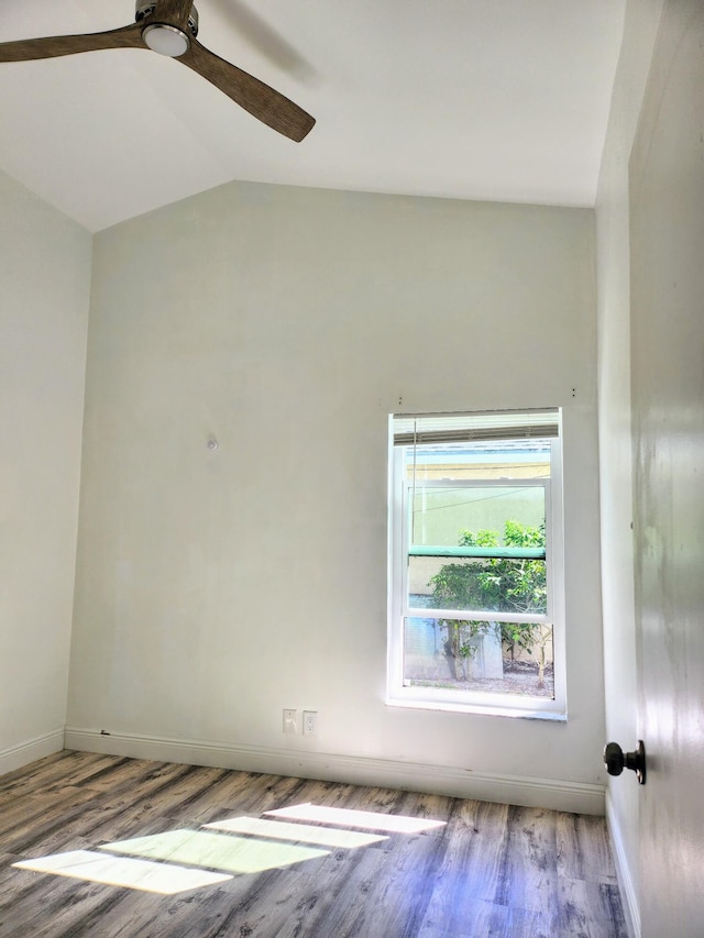 unfurnished room featuring ceiling fan, light wood-type flooring, and lofted ceiling