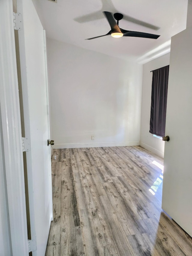 spare room featuring light hardwood / wood-style floors and ceiling fan