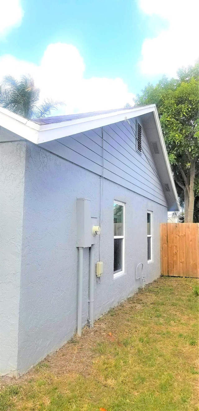 view of side of home with a lawn