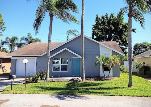 view of front facade with a garage and a front lawn