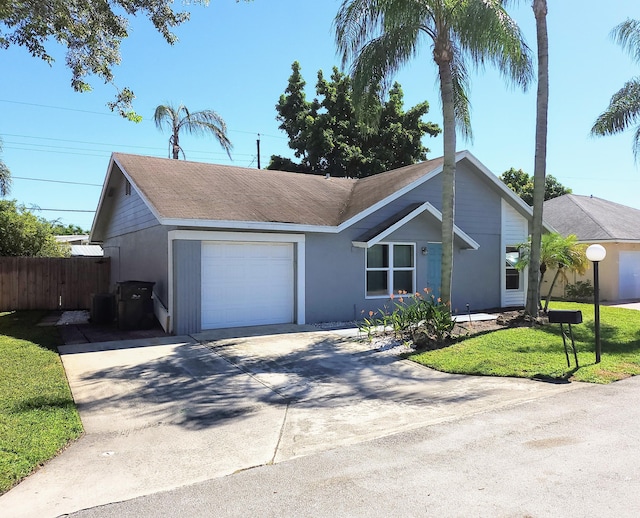 ranch-style home featuring a garage and a front lawn