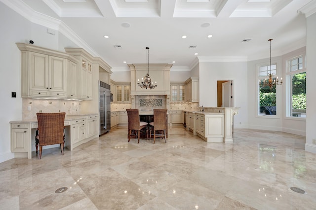 kitchen featuring ornamental molding, stainless steel built in fridge, a chandelier, and a center island