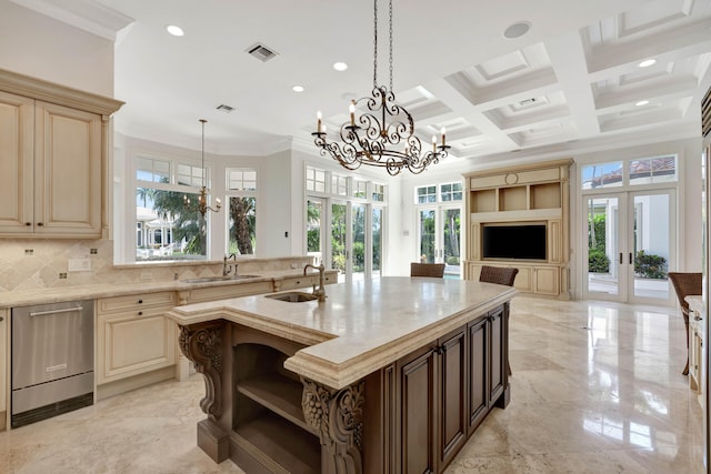 kitchen featuring coffered ceiling, decorative backsplash, a center island with sink, and a healthy amount of sunlight