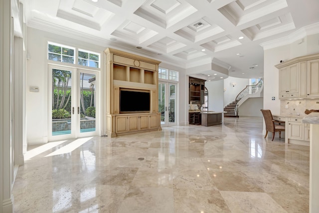 unfurnished living room with crown molding, french doors, coffered ceiling, light tile patterned flooring, and a towering ceiling