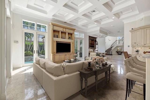 living room with a wealth of natural light, french doors, a towering ceiling, and beam ceiling
