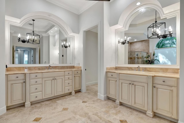 full bathroom with tiled shower, a chandelier, crown molding, and a sink