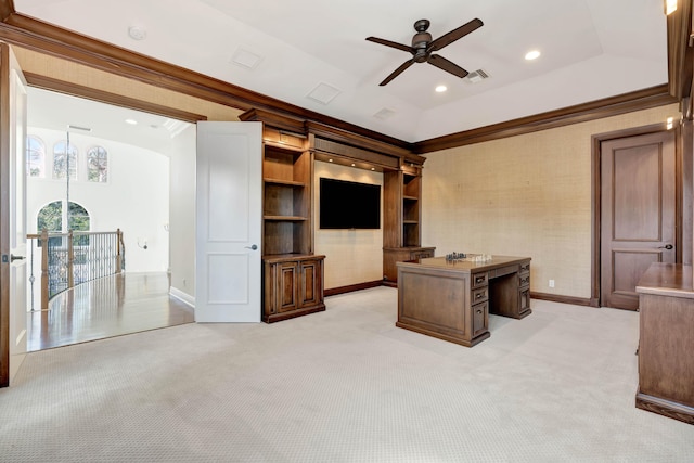 unfurnished office with a ceiling fan, ornamental molding, light colored carpet, and baseboards
