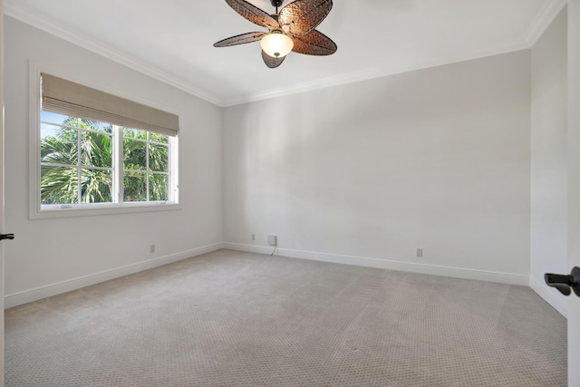 spare room featuring ceiling fan, light carpet, baseboards, and ornamental molding