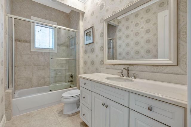 full bathroom with tile patterned flooring, vanity, toilet, and combined bath / shower with glass door