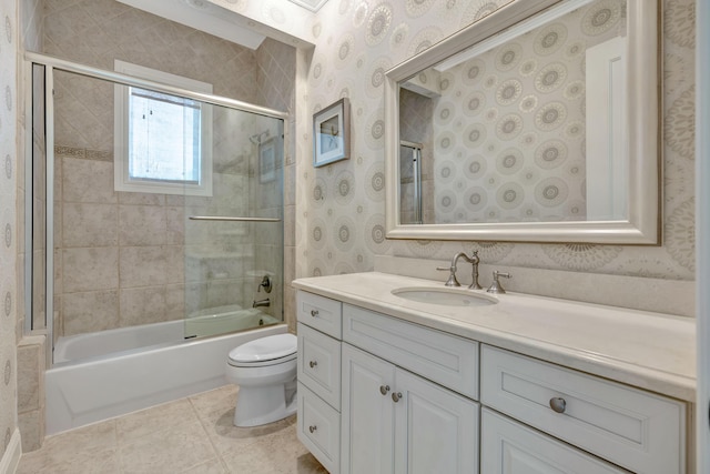 full bathroom featuring toilet, vanity, tile patterned floors, enclosed tub / shower combo, and wallpapered walls