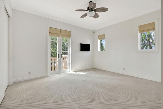 carpeted spare room featuring ornamental molding and ceiling fan