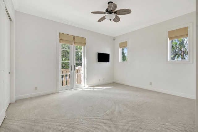 unfurnished room featuring light carpet, ceiling fan, and plenty of natural light