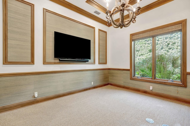carpeted empty room with ornamental molding, a notable chandelier, and visible vents
