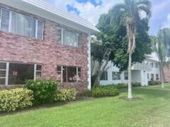 view of side of property featuring a yard