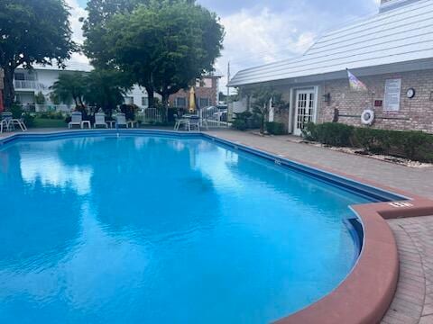 view of swimming pool with french doors