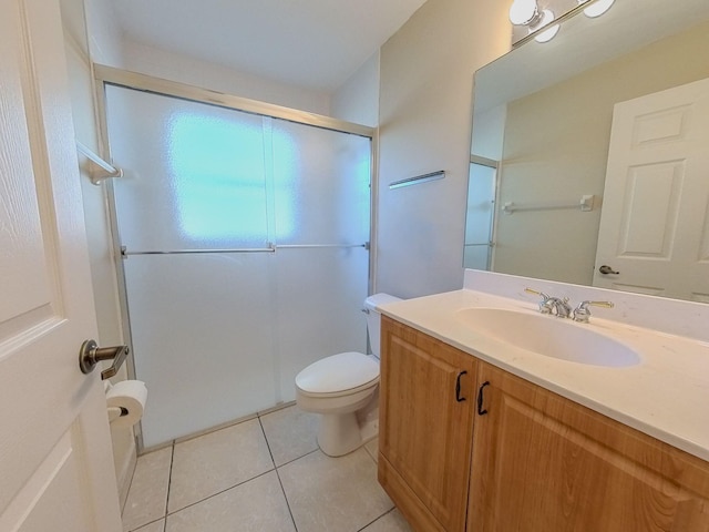 bathroom featuring toilet, vanity, and tile patterned floors