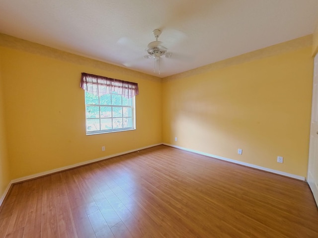 unfurnished room featuring ceiling fan and wood-type flooring