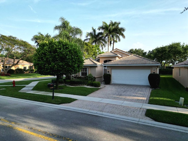 view of front of house with a front yard and a garage