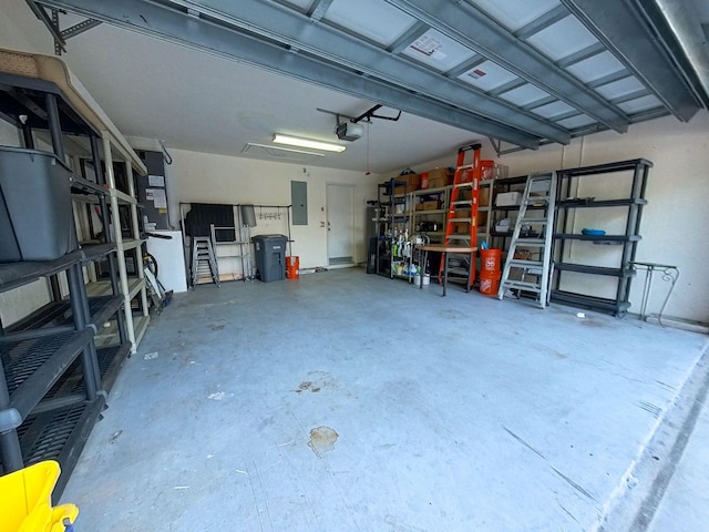 garage with a garage door opener and electric panel