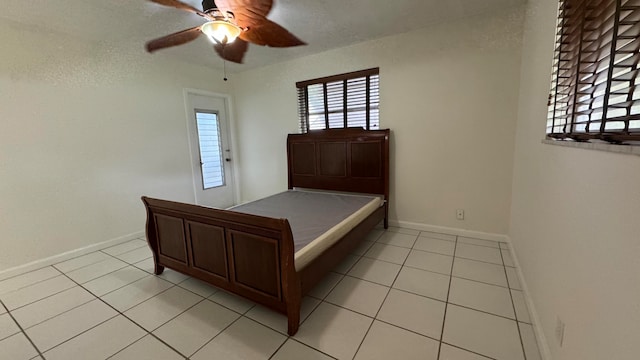 unfurnished bedroom with ceiling fan and light tile patterned flooring