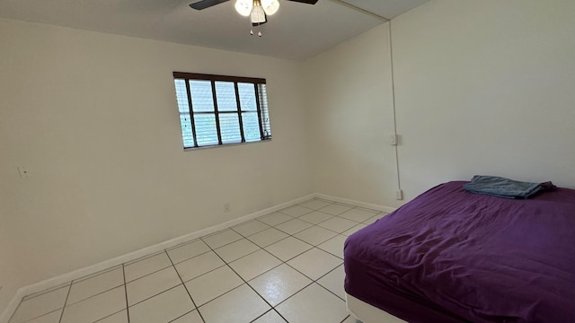 tiled bedroom featuring ceiling fan