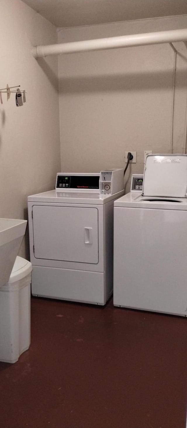 clothes washing area featuring independent washer and dryer