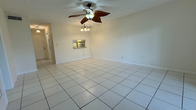 unfurnished room with ceiling fan and light tile patterned floors