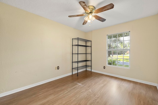 unfurnished room with ceiling fan and wood-type flooring