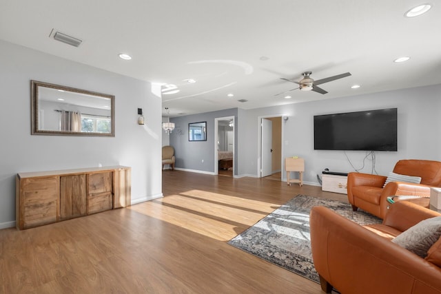 living room featuring ceiling fan and hardwood / wood-style flooring