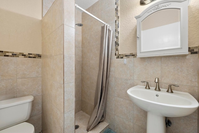 bathroom with tile walls, toilet, and a shower with curtain