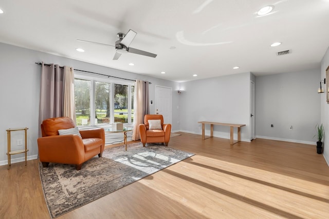 sitting room featuring light hardwood / wood-style flooring and ceiling fan