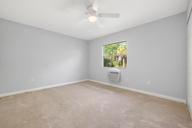 spare room with carpet floors, ceiling fan, and an AC wall unit