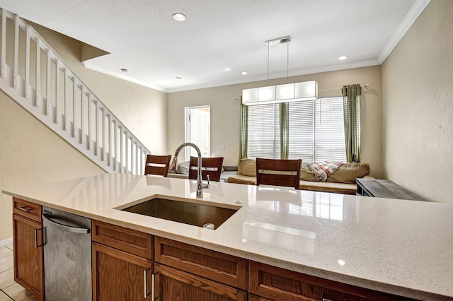 kitchen with stainless steel dishwasher, sink, plenty of natural light, and light stone counters