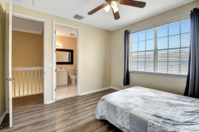 bedroom featuring ceiling fan, hardwood / wood-style flooring, and ensuite bathroom