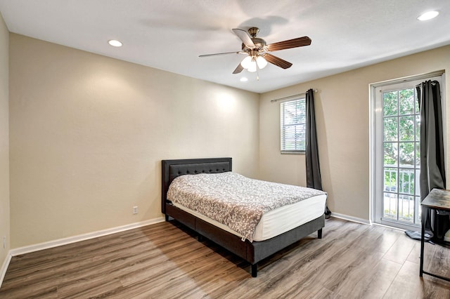 bedroom with hardwood / wood-style flooring, access to exterior, and ceiling fan