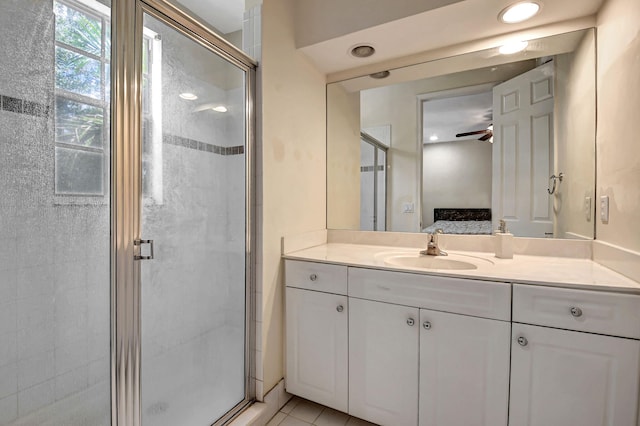 bathroom with ceiling fan, vanity, walk in shower, and tile patterned floors