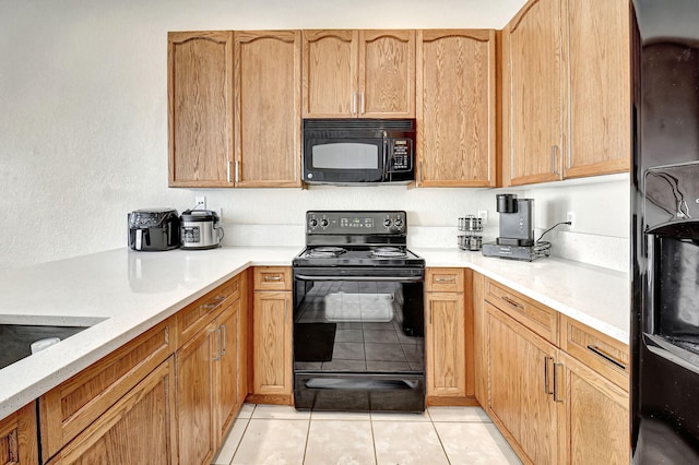 kitchen with black appliances and light tile patterned floors