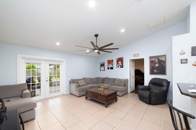 living room featuring ceiling fan, vaulted ceiling, french doors, and light tile patterned floors