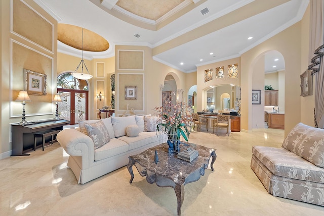 living room featuring a raised ceiling, crown molding, a high ceiling, and light tile patterned floors