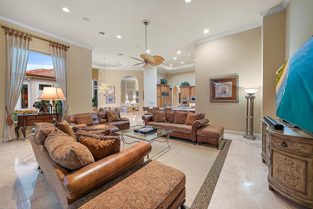 tiled living room featuring ceiling fan with notable chandelier and ornamental molding