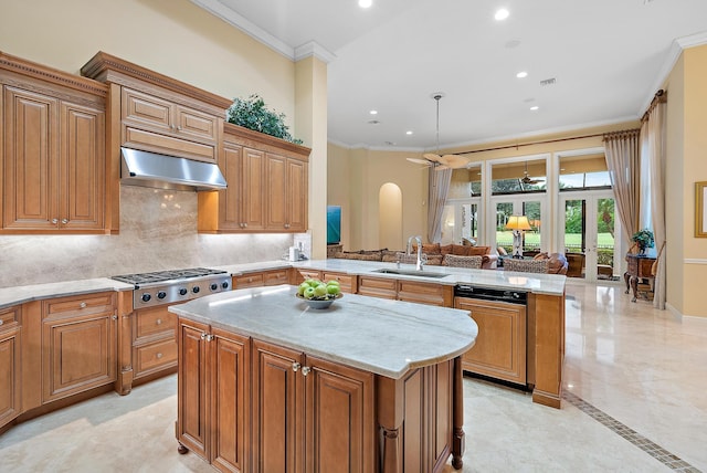 kitchen featuring sink, light stone countertops, stainless steel gas cooktop, light tile patterned floors, and kitchen peninsula